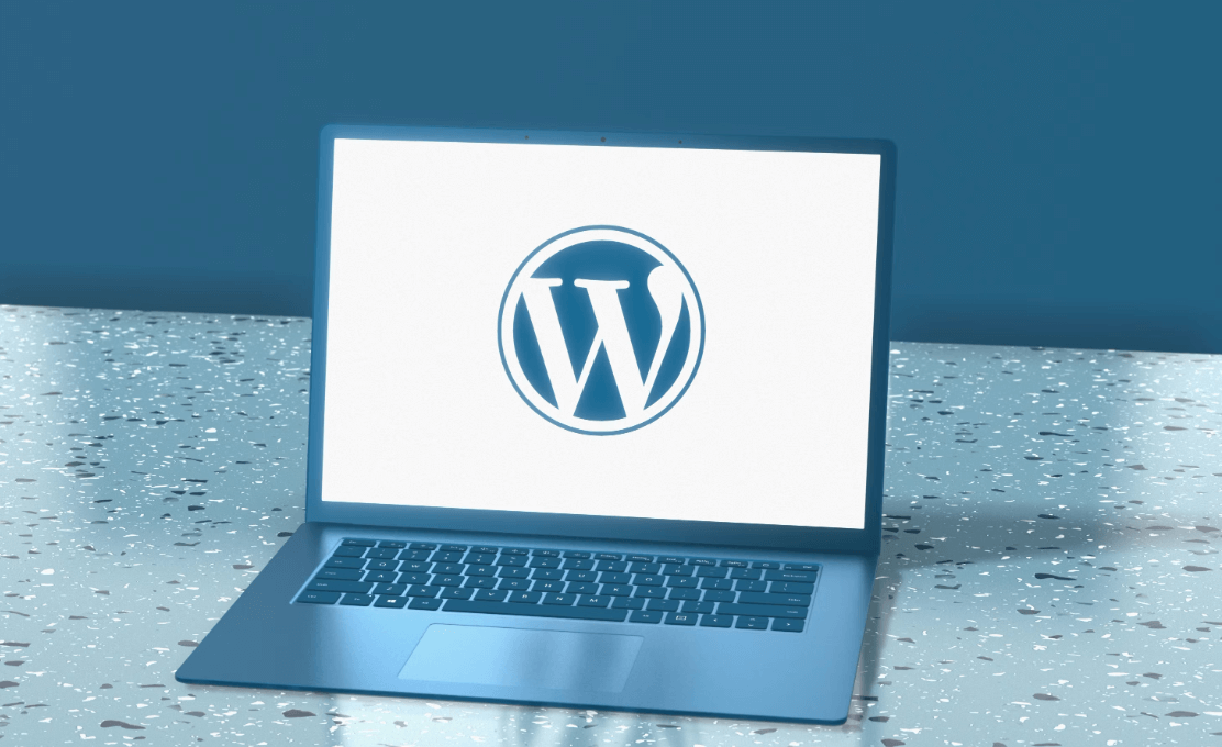 Laptop showing WordPress logo for beginners tutorial